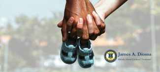 Two people holding hands and carrying small baby shoes